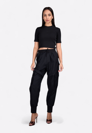 Model wearing black short-sleeve crop top, front view, East Vibe